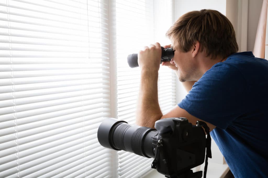 Man Spying With Binoculars