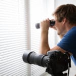 Man Spying With Binoculars