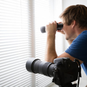 Man Spying With Binoculars
